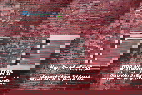 a window AC unit mounted in a worn, red brick wall