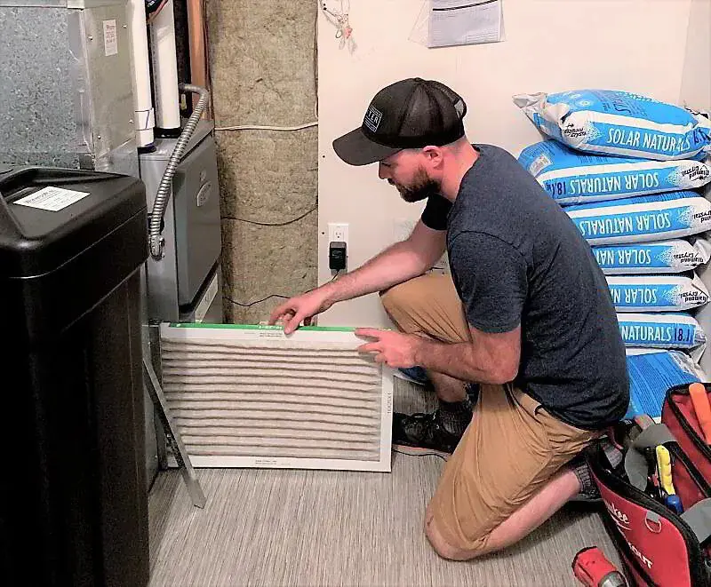 HVAC tech changing an air filter